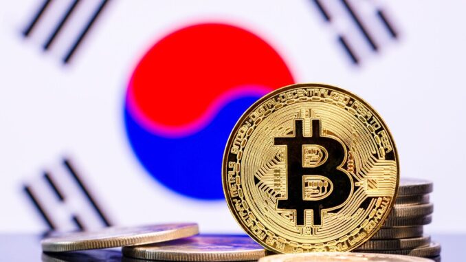 An image showing a representation of a bitcoin token against the backdrop of a South Korean flag.